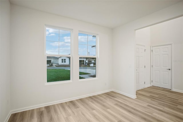 spare room featuring light wood-type flooring