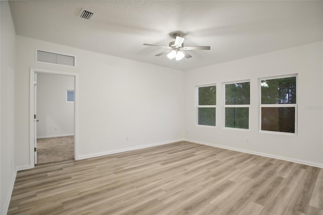 empty room featuring light wood-type flooring and ceiling fan