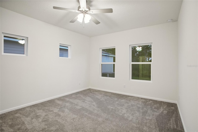 spare room featuring ceiling fan and carpet floors