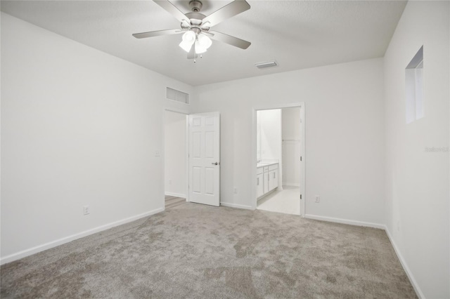 spare room with ceiling fan and light colored carpet