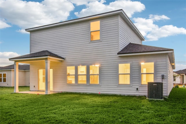 back of house featuring a yard, cooling unit, and a patio area