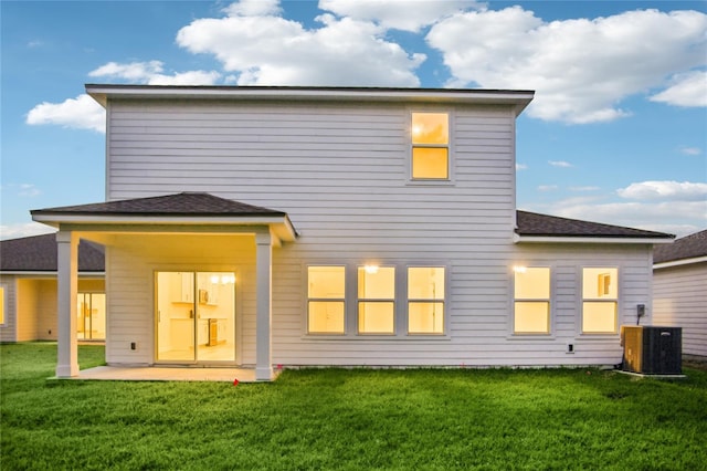 back of house featuring a yard, cooling unit, and a patio area