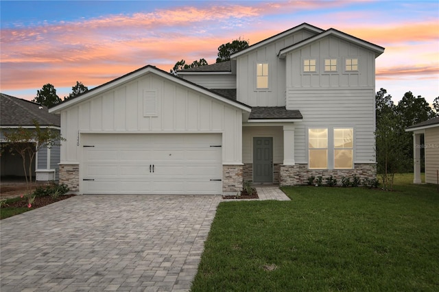 view of front of property with a lawn and a garage