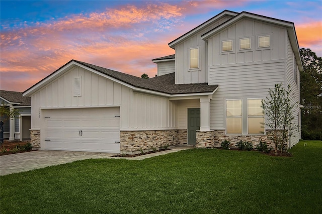 view of front of home with a yard and a garage