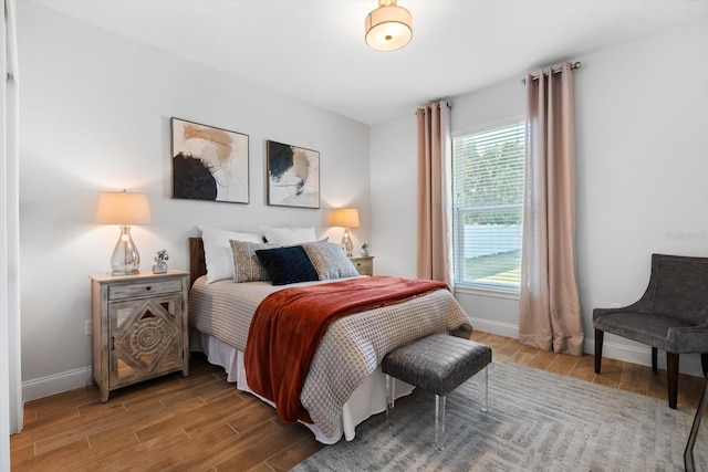 bedroom featuring hardwood / wood-style flooring and multiple windows