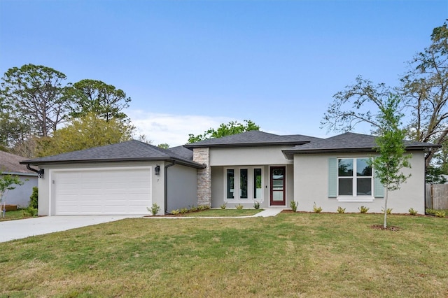 prairie-style house with fence, an attached garage, concrete driveway, a front yard, and stucco siding
