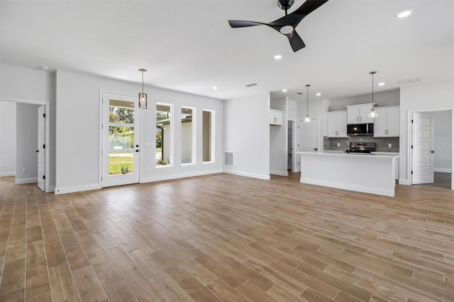 unfurnished living room featuring baseboards, light wood-type flooring, recessed lighting, and a ceiling fan