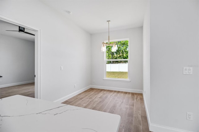 interior space with baseboards and wood finished floors