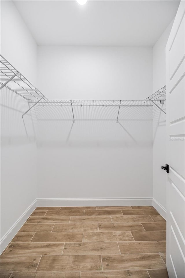 walk in closet featuring wood tiled floor