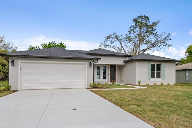 prairie-style house with stucco siding, driveway, a front lawn, and an attached garage