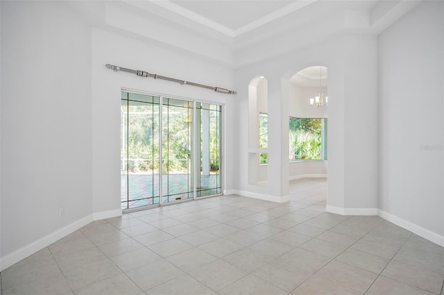 unfurnished room featuring light tile patterned flooring and an inviting chandelier