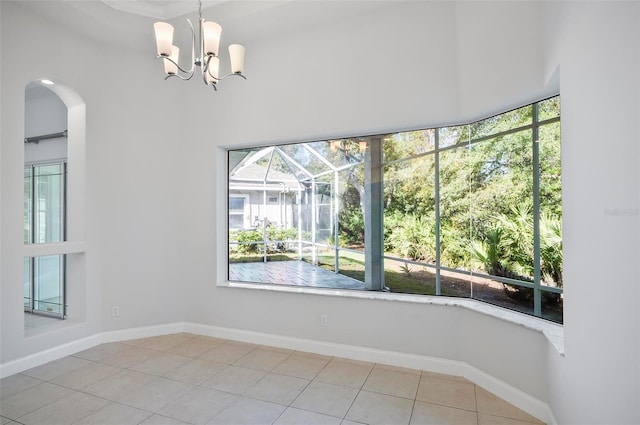 unfurnished room featuring tile patterned floors and an inviting chandelier