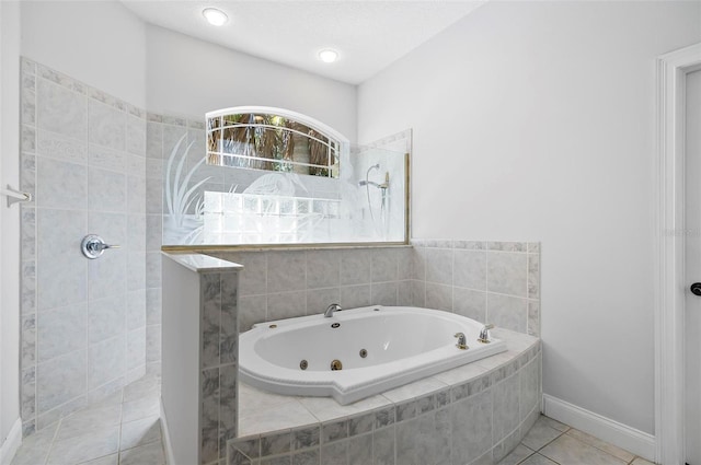 bathroom with tile patterned flooring and a relaxing tiled tub