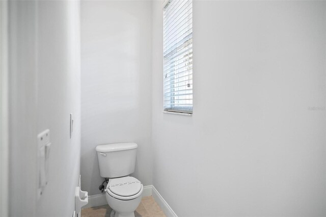 bathroom featuring tile patterned flooring and toilet