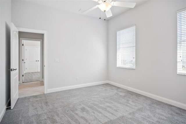 carpeted empty room featuring ceiling fan and a healthy amount of sunlight