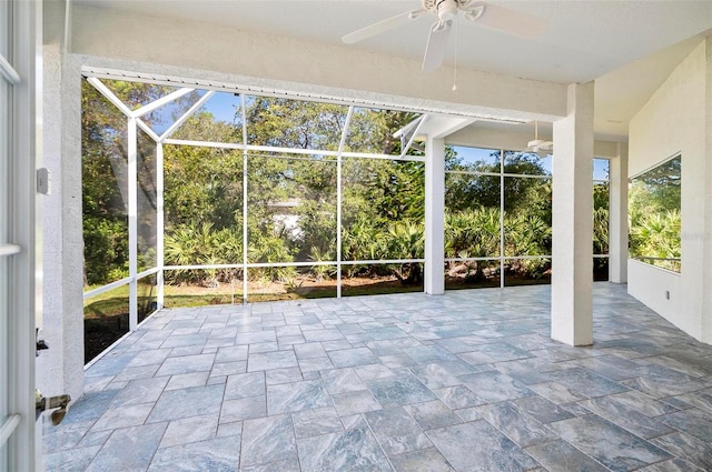 unfurnished sunroom featuring ceiling fan