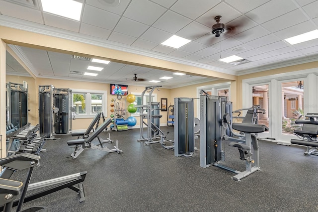 exercise room featuring a paneled ceiling, ceiling fan, and ornamental molding