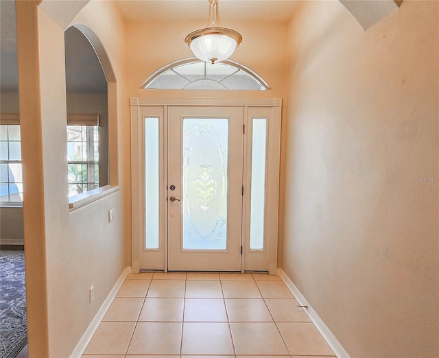 8 Burning Sands Ln, Palm Coast, FL 32137 - foyer with arched walkways, baseboards, and light tile patterned flooring