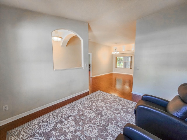 interior space with a notable chandelier and hardwood / wood-style flooring