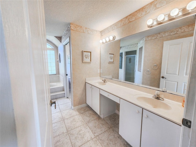 8 Burning Sands Ln, Palm Coast, FL 32137 - bathroom featuring a textured ceiling, tile patterned floors, a shower stall, double vanity, and a garden tub