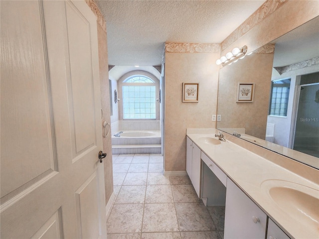 8 Burning Sands Ln, Palm Coast, FL 32137 - bathroom with a textured ceiling, double vanity, a bath, a shower with shower door, and tile patterned flooring