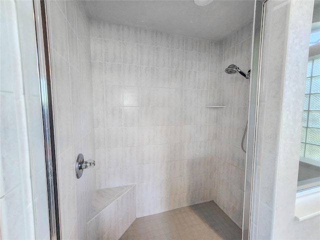 bathroom featuring a tile shower