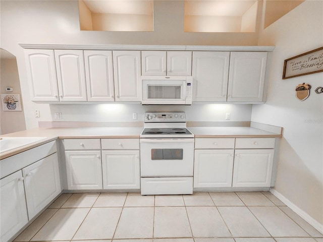 8 Burning Sands Ln, Palm Coast, FL 32137 - kitchen with white appliances, white cabinets, light countertops, light tile patterned floors, and a sink