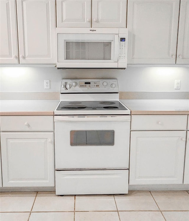8 Burning Sands Ln, Palm Coast, FL 32137 - kitchen with white appliances, light tile patterned flooring, light countertops, and white cabinets