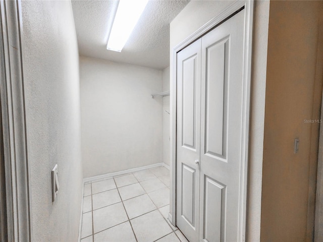 walk in closet with light tile patterned flooring