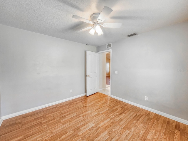 8 Burning Sands Ln, Palm Coast, FL 32137 - unfurnished room with light wood-style flooring, baseboards, a textured ceiling, and ceiling fan