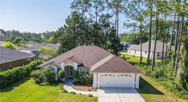 8 Burning Sands Ln, Palm Coast, FL 32137 - view of front of property with driveway, roof with shingles, stucco siding, and a front lawn