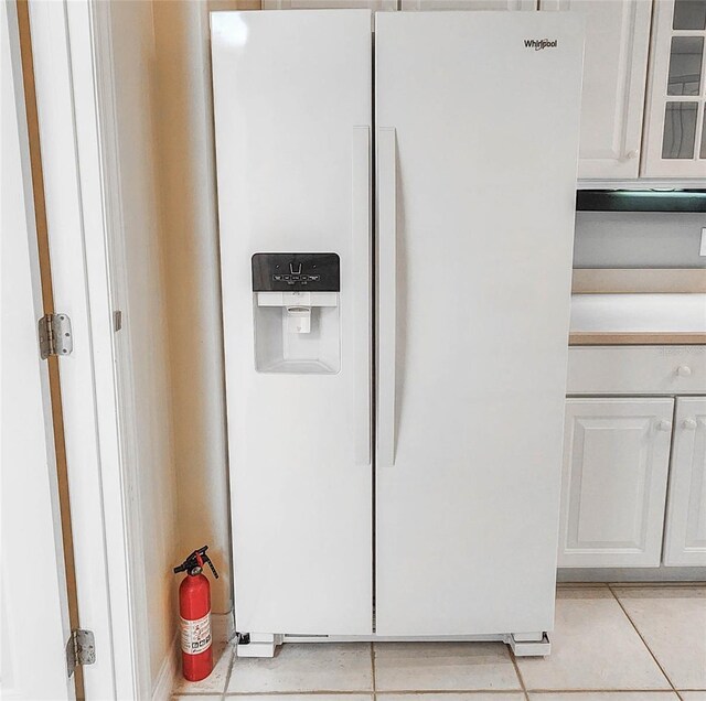 8 Burning Sands Ln, Palm Coast, FL 32137 - kitchen view of white refrigerator with ice dispenser, white cabinets, and glass insert cabinets