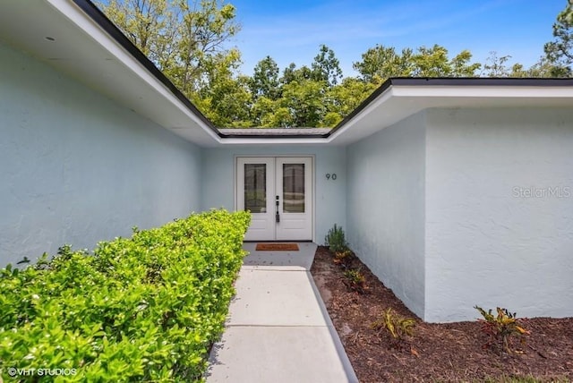 view of exterior entry featuring french doors