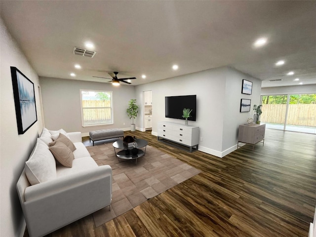 living room with dark hardwood / wood-style floors and ceiling fan