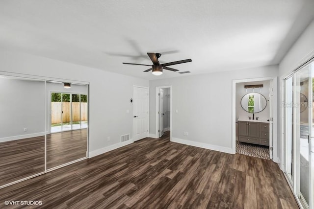 unfurnished room with ceiling fan, sink, and dark hardwood / wood-style floors