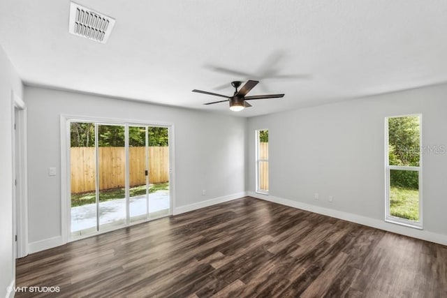 empty room with ceiling fan and dark hardwood / wood-style flooring