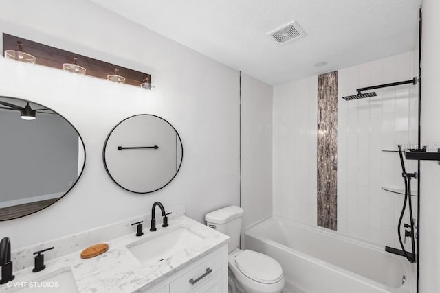 full bathroom featuring vanity, toilet, and tiled shower / bath