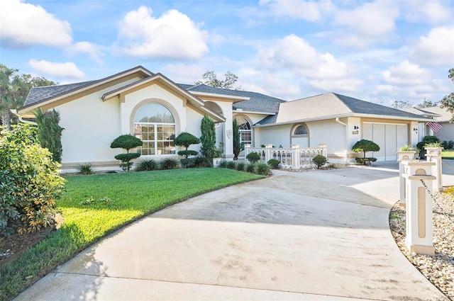 single story home with a garage and a front lawn