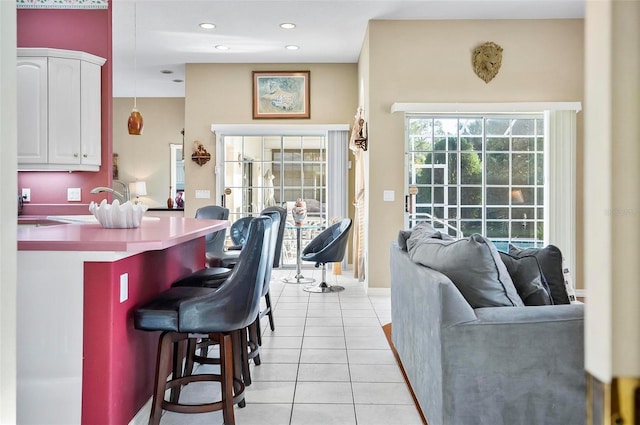 interior space with white cabinets and light tile patterned flooring