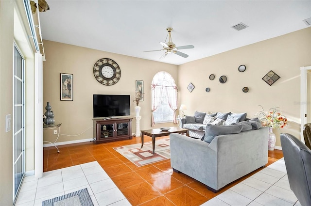 tiled living room featuring ceiling fan