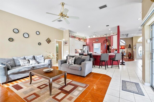 tiled living room with ceiling fan