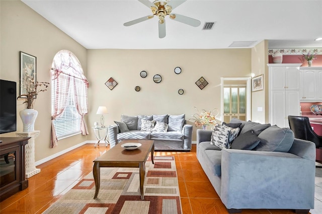 tiled living room featuring ceiling fan