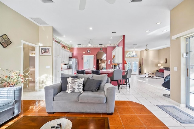 tiled living room featuring plenty of natural light and ceiling fan