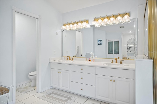 bathroom with tile patterned flooring, vanity, and toilet