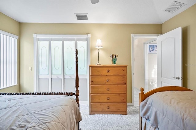 carpeted bedroom featuring multiple windows, a closet, and ceiling fan