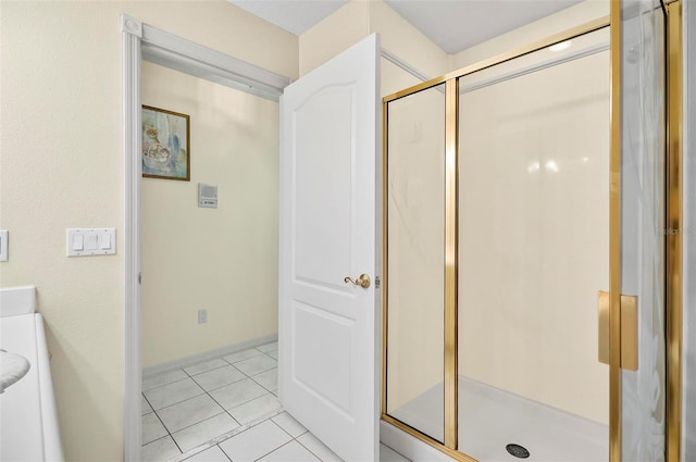 bathroom with tile patterned flooring and a shower with shower door