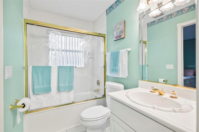 full bathroom featuring tile patterned flooring, toilet, combined bath / shower with glass door, and vanity