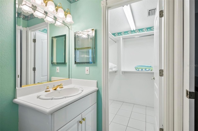 bathroom featuring tile patterned flooring and vanity