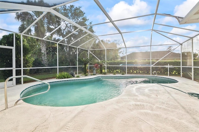 view of pool featuring a patio area and a lanai