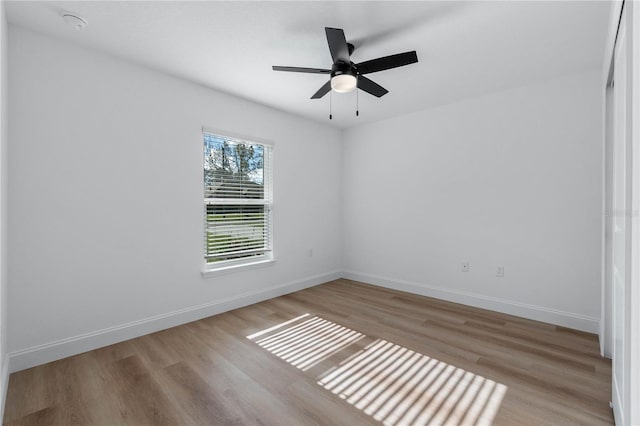 spare room with light wood-type flooring and ceiling fan